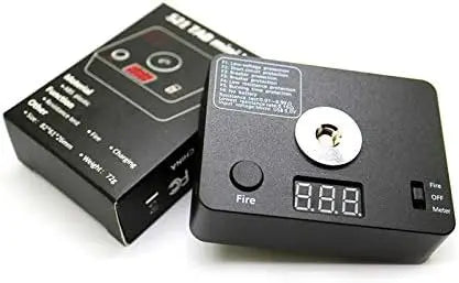 Black electronic device with digital display and button, next to its packaging on a white background
