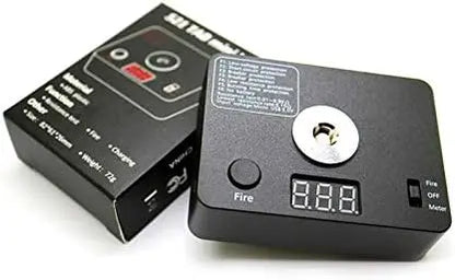 Black electronic device with digital display and button, next to its packaging on a white background