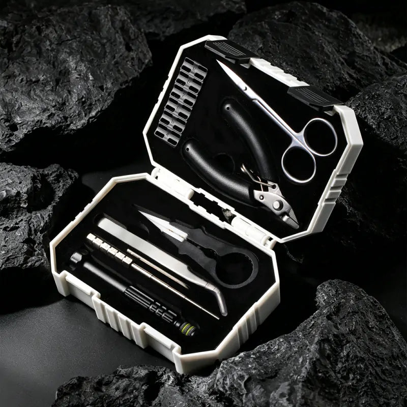 Thundercloud X Coilturd Pro Tool Kit with various tools in an open case on a rocky surface