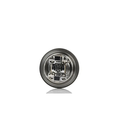 Circular metallic object with intricate design on a white background