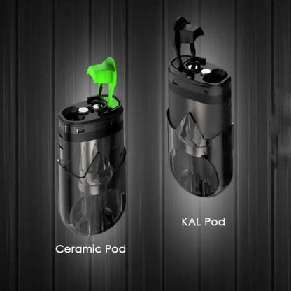 Two cylindrical vape pods shown side by side against a dark wood background. The left pod is labeled 'Ceramic Pod' and has a bright green mouthpiece.